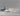 M1 sectional sofa set in a neutral color, displayed next to packaging boxes labeled Rove, showcasing a minimalist and modern design